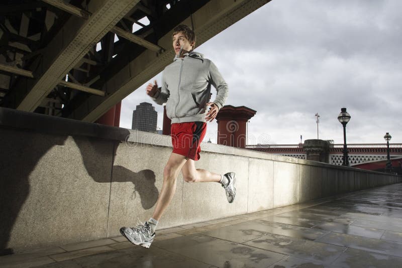 Young Man Jogging On Stormy Day