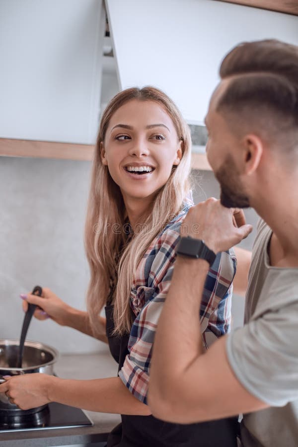 Young Man Joking With His Wife In The Kitchen Stock Im