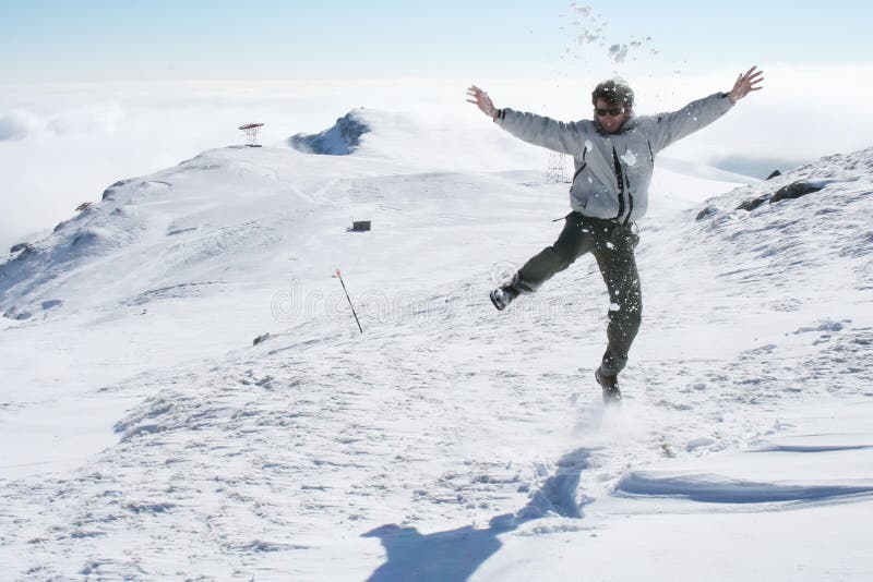 Young man jumping for fun in the snow