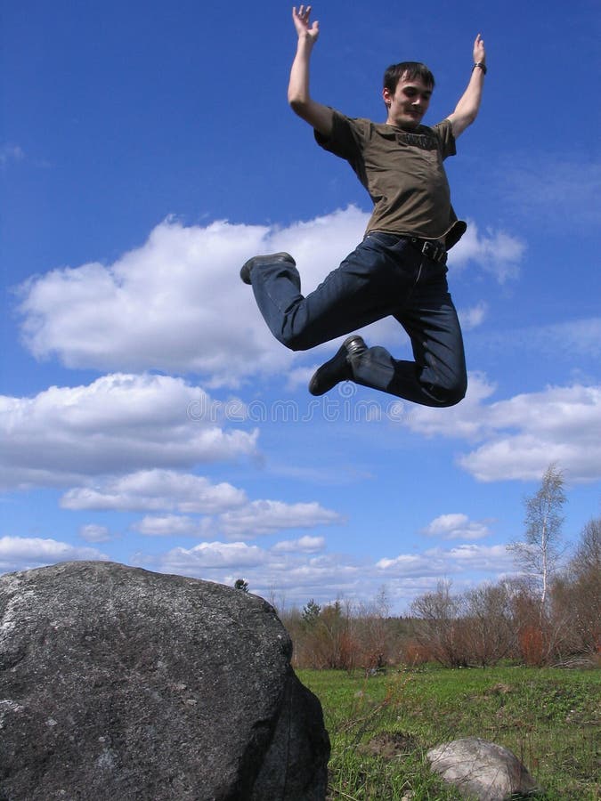Young man jumping from stone 2