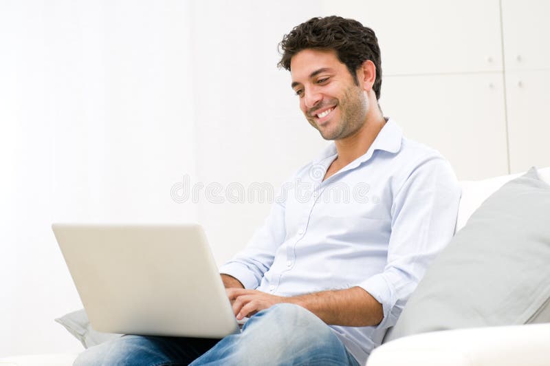 Young man at laptop stock photography