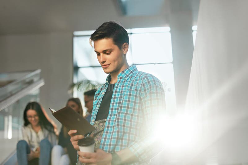 Young Man Learning, Reading Notes in Book royalty free stock image