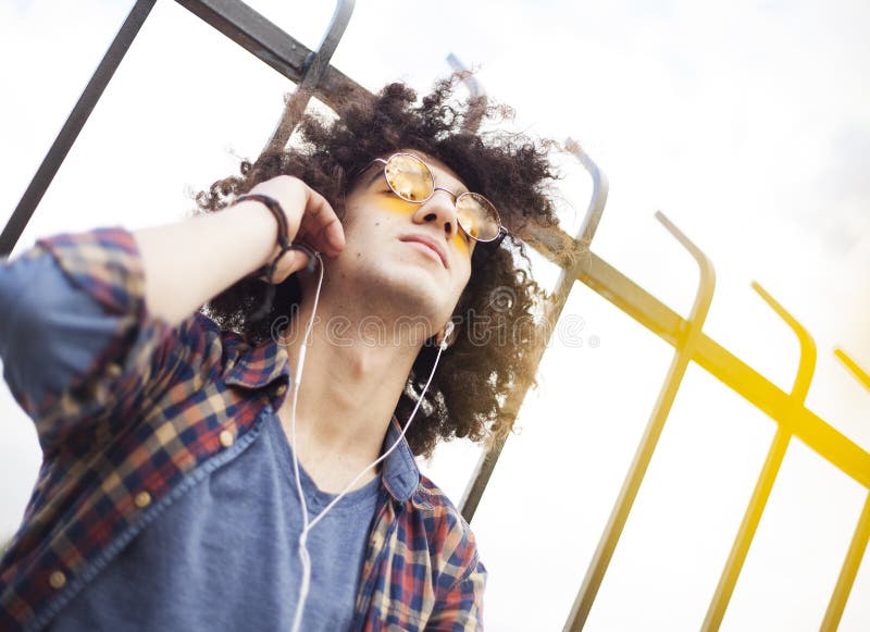 Young man listening music with earphones