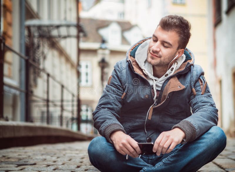 Young man listening music on his phone