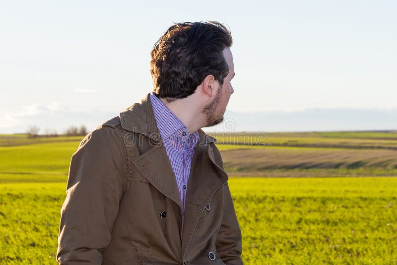 Young Man Looking Back on the Field stock photo Young Man Looking Back on the Field stock photo