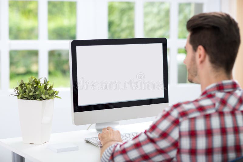 Young man looking at computer screen royalty free stock photos