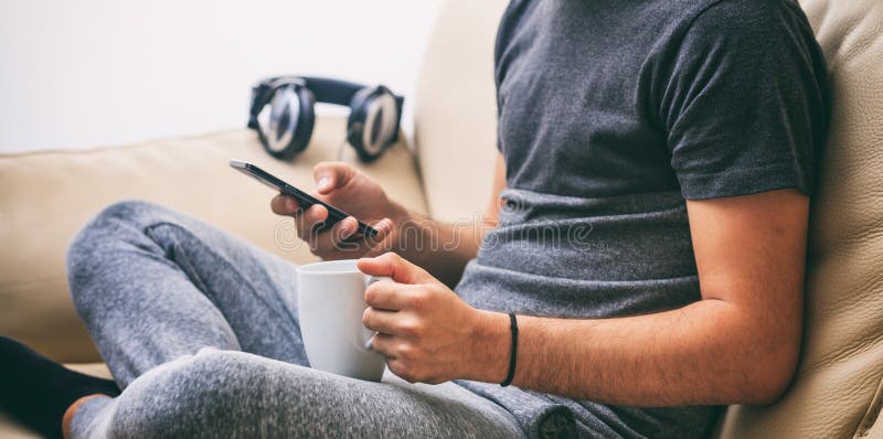 Man looking at his smart phone at home