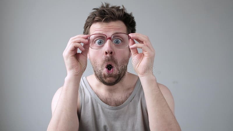 Young Man Looking through Huge Glasses in Shock with Surprise ...