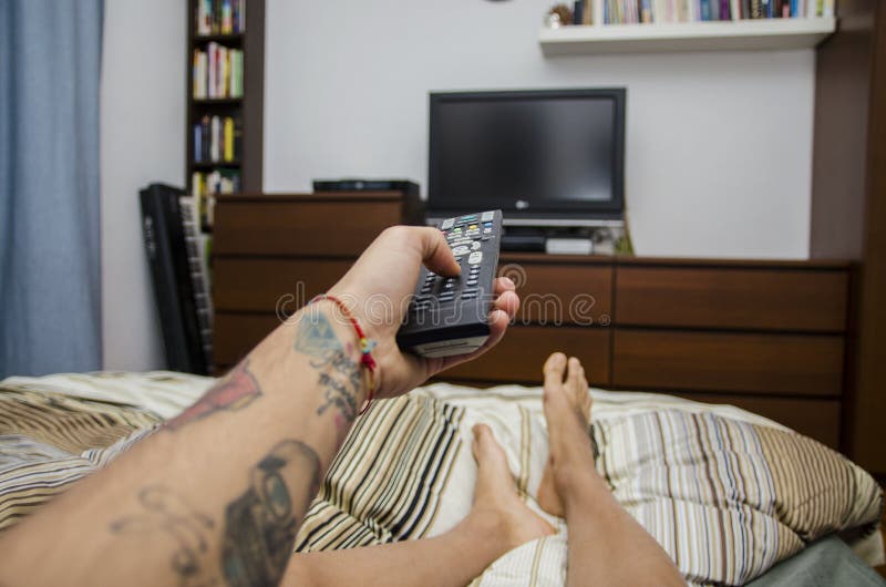 Young Man Lying on Bed Watching Television. Self Stock Photo Image of