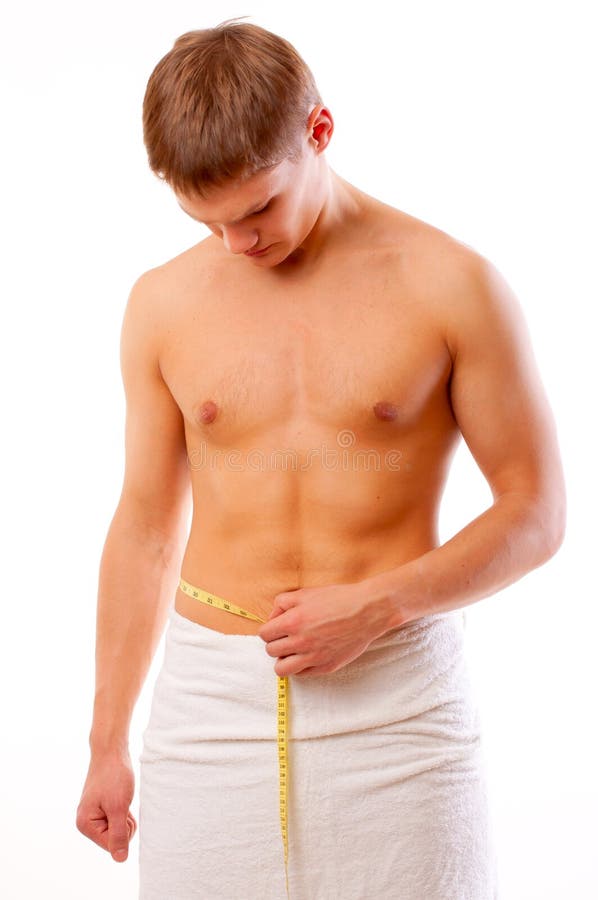 Man measuring his waist with a tape measure 2246454 Stock Photo at