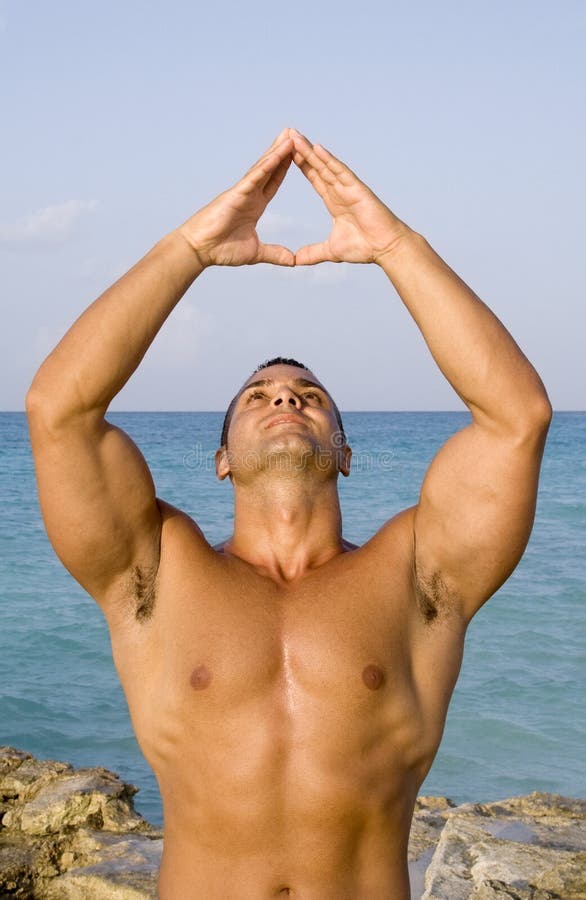 Young Man Meditating Near Ocean