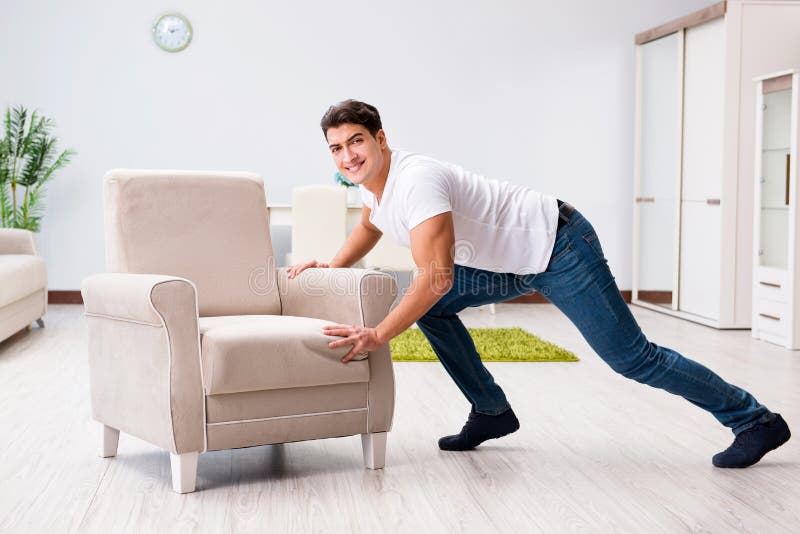 The Young Man Moving Furniture at Home Stock Photo Image of happy