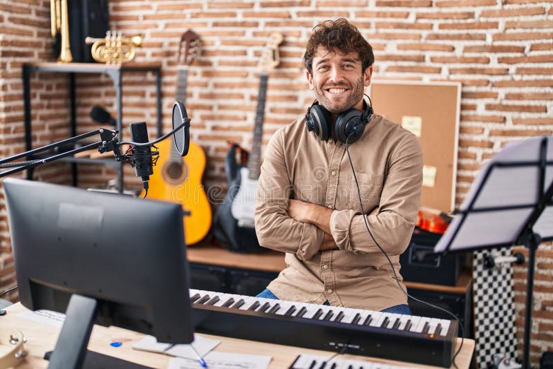 Young Man Musician Smiling Confident Sitting with Arms Crossed Gesture