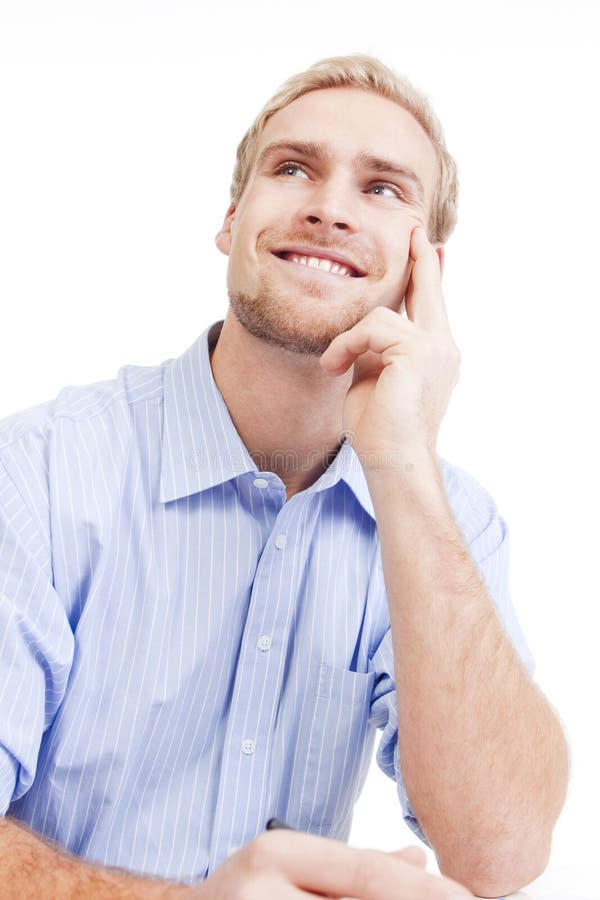 Young man at office daydreaming