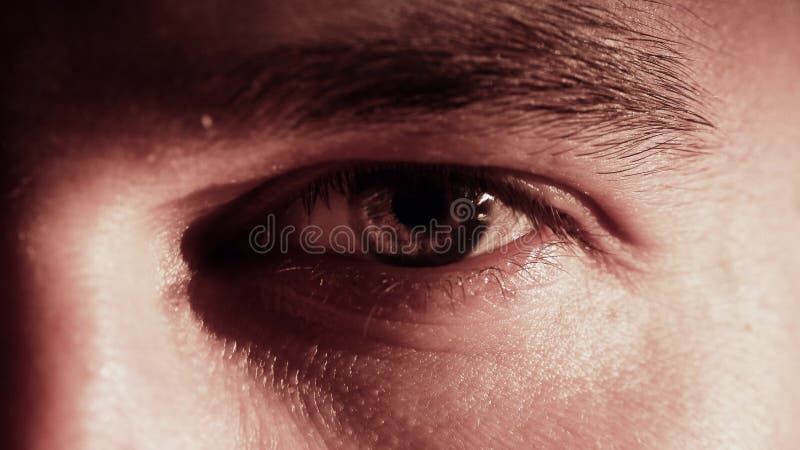 Young caucasian man opens and closes his eye