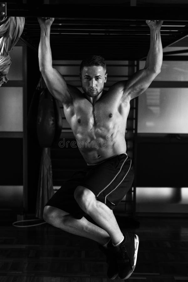 Young Man Performing Hanging Leg Raises Abs Exercise Stock Photo ...