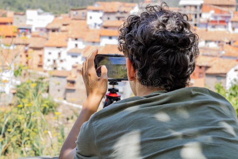 Young man photographing a town royalty free stock photo