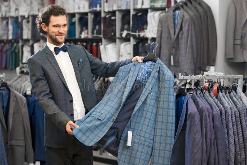 Young Man Picking Up Suit in Store. Stock Image - Image of wear ...