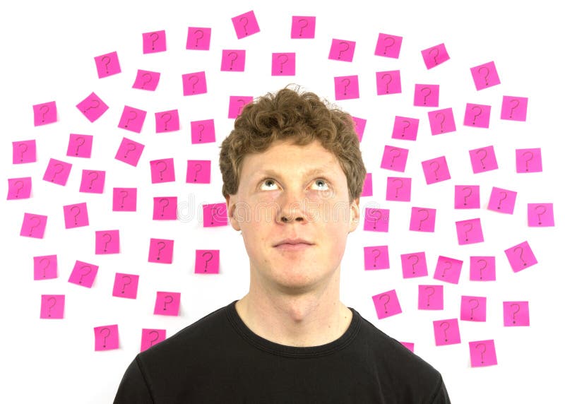 Young man with pink sticky notes question marks de