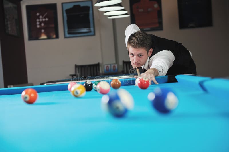 Young man play pro billiard game