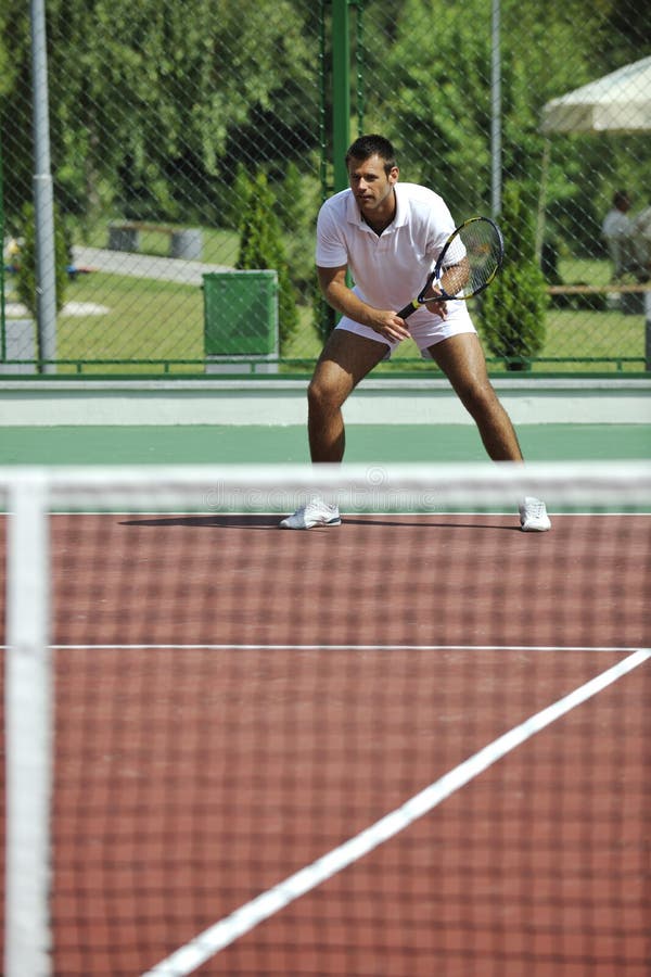 Young man play tennis outdoor