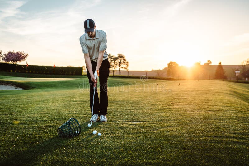 Download Young man playing golf stock image. Image of people, orange - 83884557