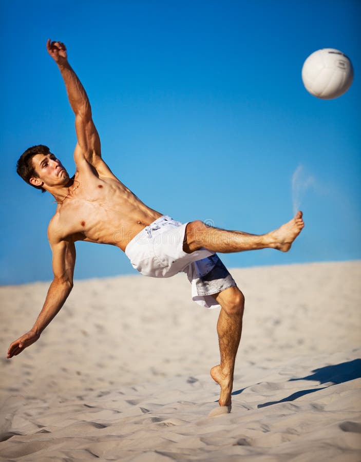 Young man playing soccer stock photo. Image of sand, leisure - 16439910