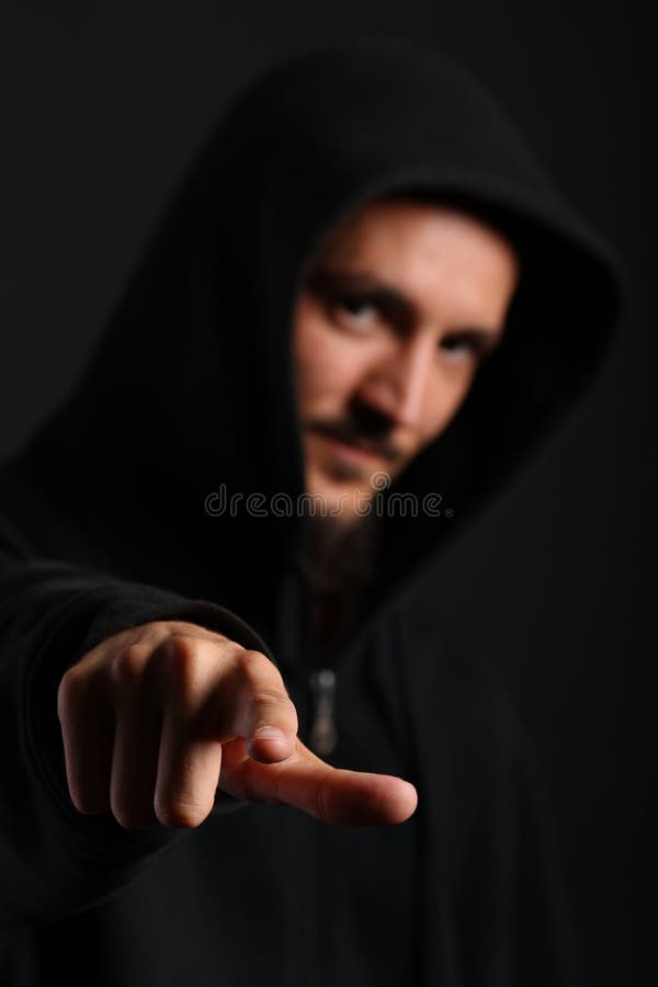 Young man points his finger towards the camera
