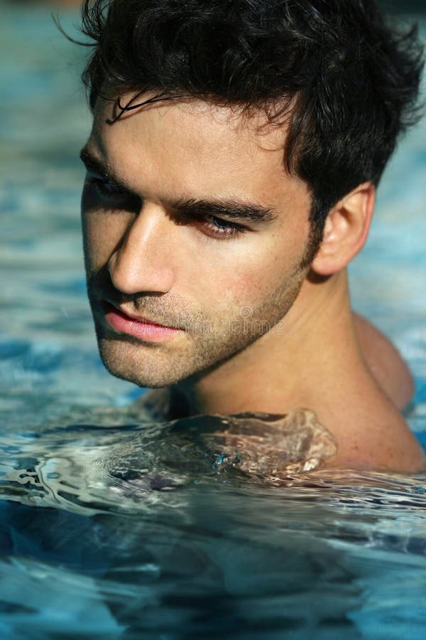 Young man in pool. Portrait of a handsome young man in swimming pool Young man in pool. Portrait of a handsome young man in swimming pool