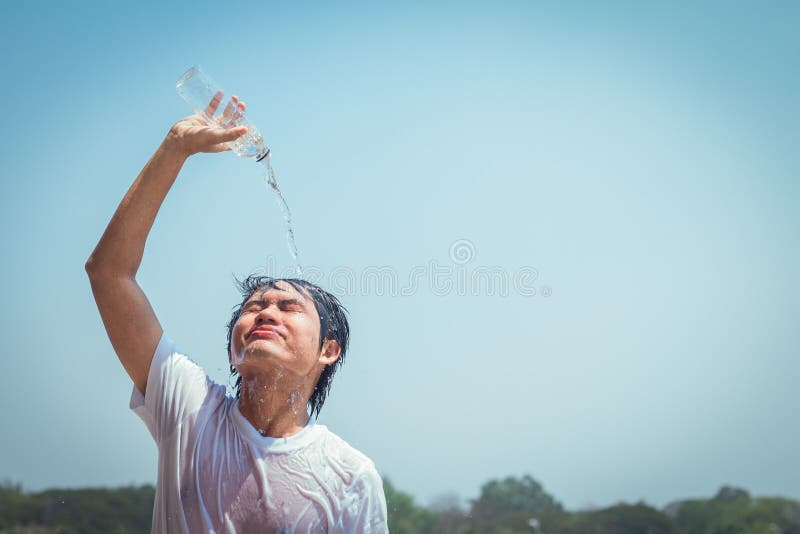 Young man pouring water stock photo. Image of summer 91484944