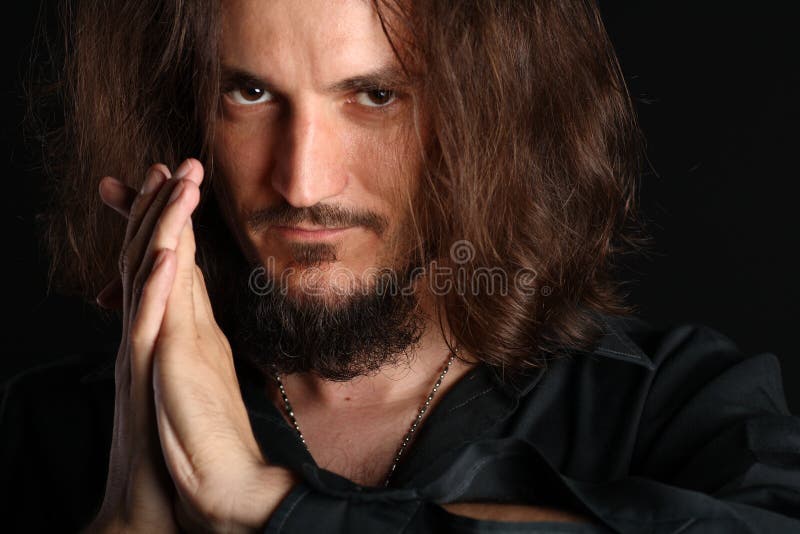 Young man praying and looking at camera isolated o royalty free stock photos Young man praying and looking at camera isolated o royalty free stock photos