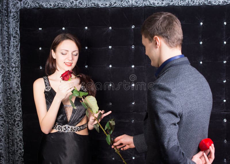 Young man proposing to his sweetheart