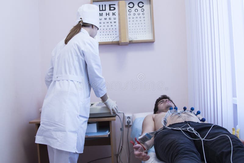 Female doctor analyzing ECG electrocardiogram of patient at in hospital stock images Female doctor analyzing ECG electrocardiogram of patient at in hospital stock images