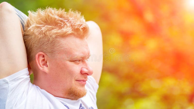 A young man relaxes in nature