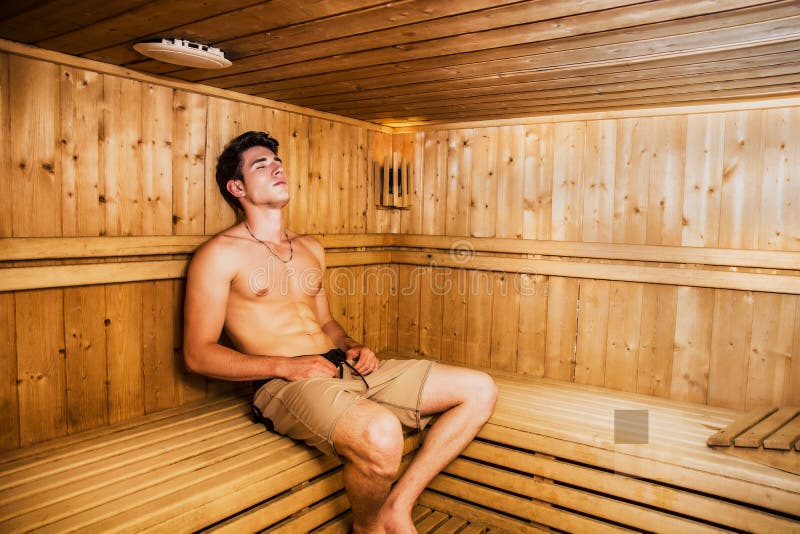 Young Man Relaxing in Sauna, Sitting on Wooden.