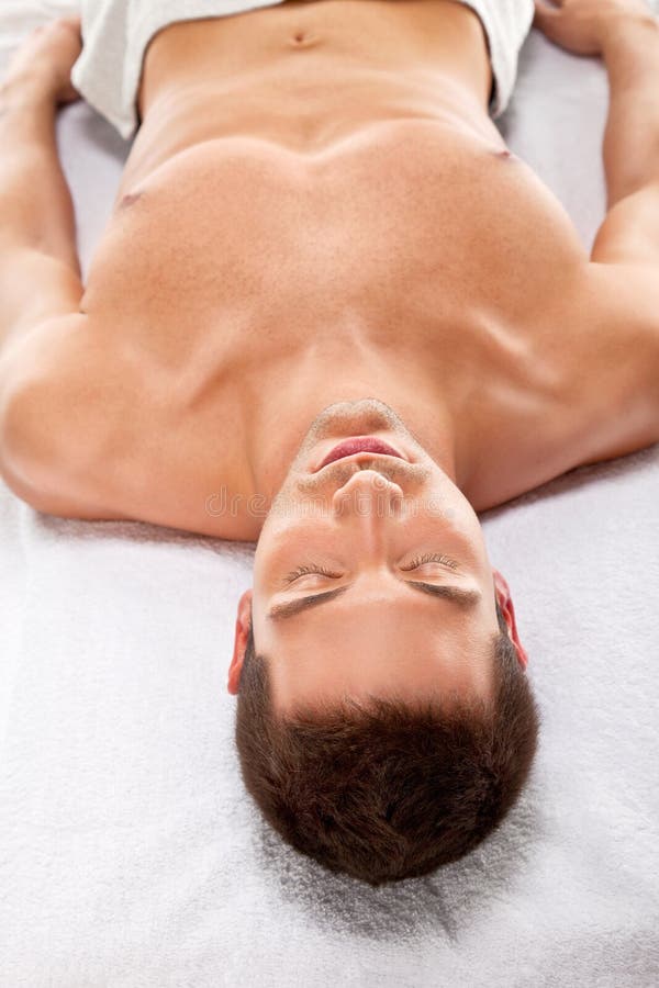 A young man is relaxing in spa center stock images