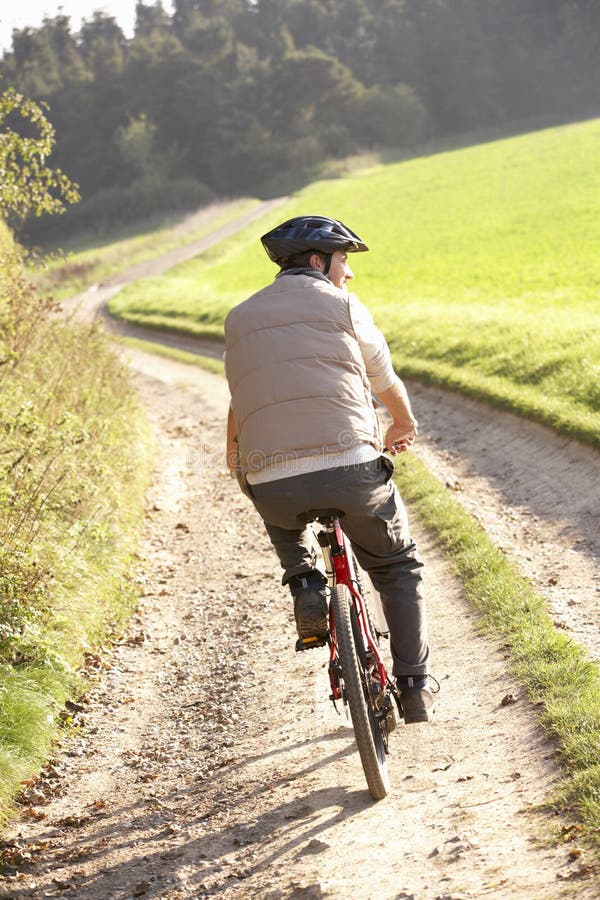 Young man rides his bike in park stock photos Young man rides his bike in park stock photos
