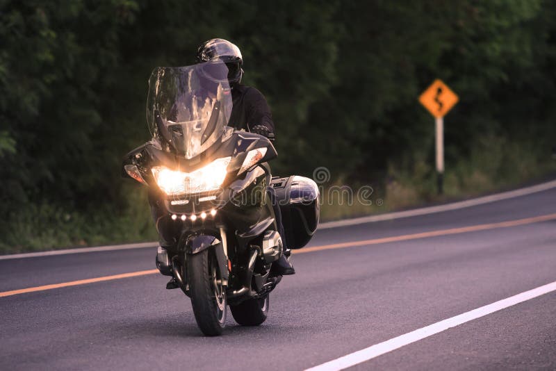 Young man riding big motorcycly on asphalt road use royalty free stock photos Young man riding big motorcycly on asphalt road use royalty free stock photos