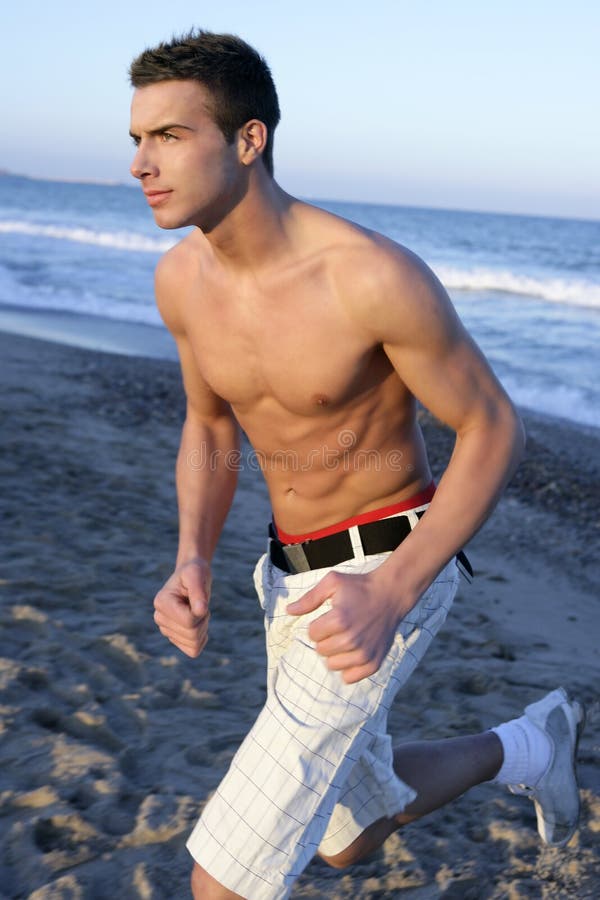 Young man running on the blue beach