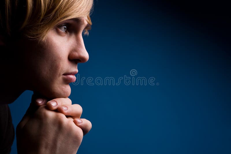 Young man with a serious look over blue