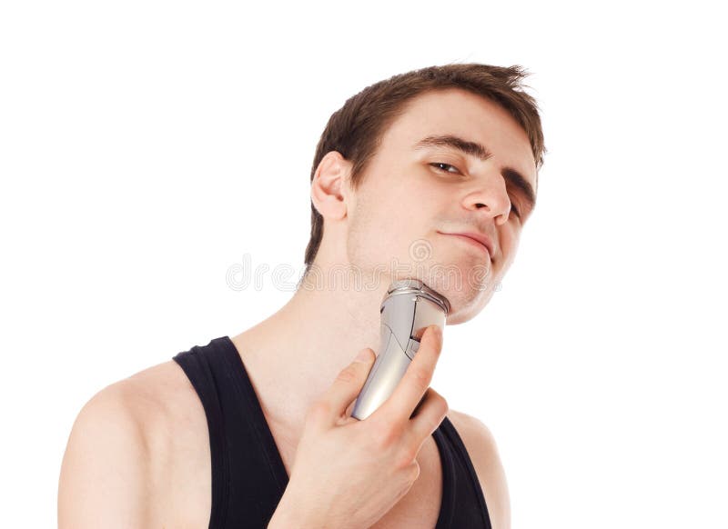 Young Man Shaving His Beard Off with an Electric Razor Stock Image