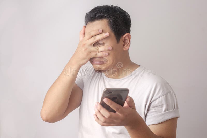 Sad man has bad online chat news and feels disappointed on the smartphone.  Stock Photo by ©sevendeman 506404148