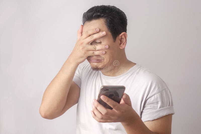 Sad Asian Man Has Bad Online Chat News And Feels Disappointed On The  Smartphone. Stock Photo, Picture and Royalty Free Image. Image 175416709.