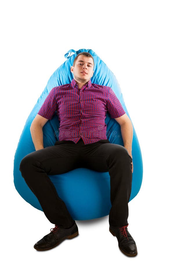 Young man sitting on blue beanbag royalty free stock image Young man sitting on blue beanbag royalty free stock image