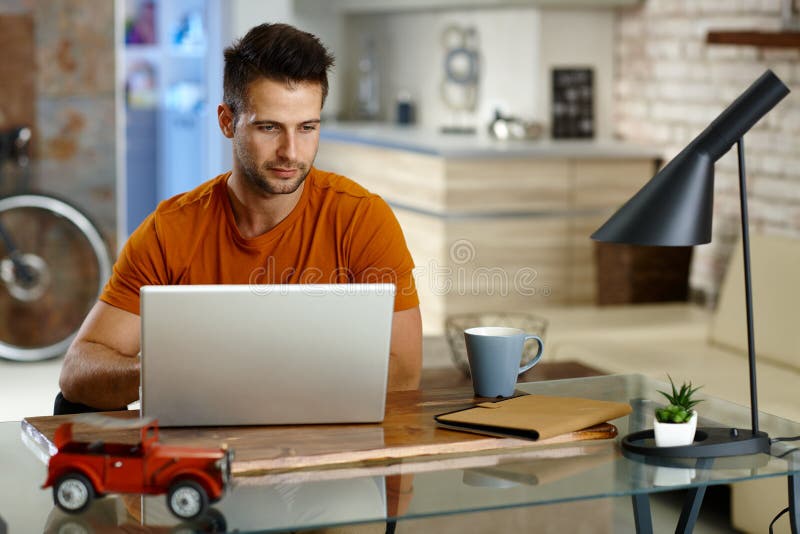 Young man working at home stock image