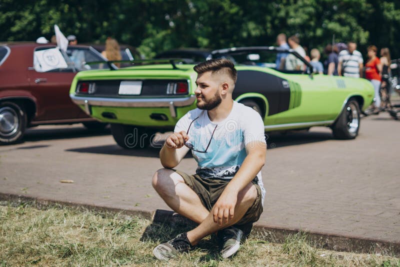 Young Man Sitting on Green Car Background Stock Image - Image of people,  hair: 178458815