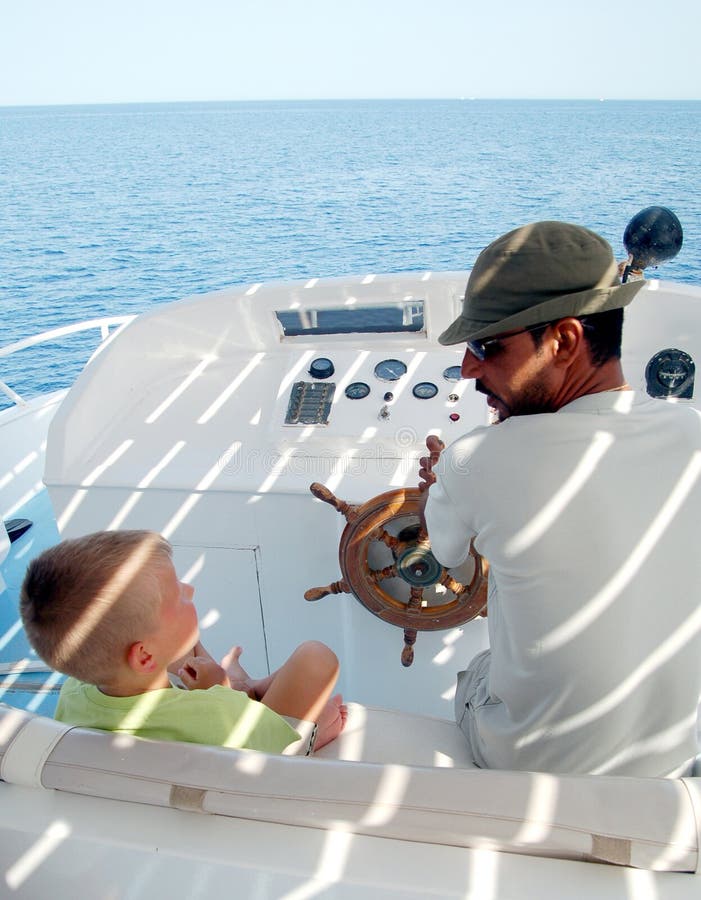 Young man and son on sailboat