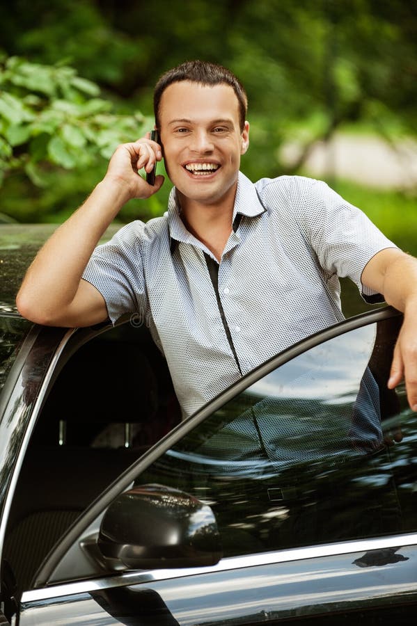 Young man speaking on telephone about car stock photos Young man speaking on telephone about car stock photos