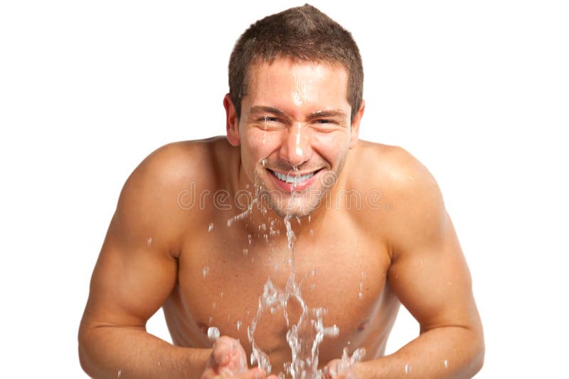 Young Man Spraying Water on His Face after Shaving in the Bathroom