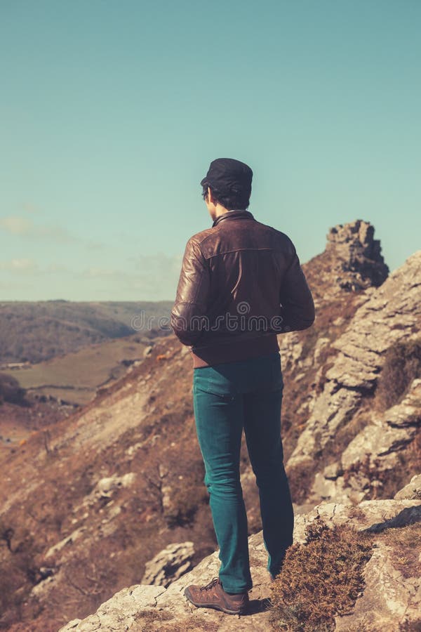 Young man standing in the mountains